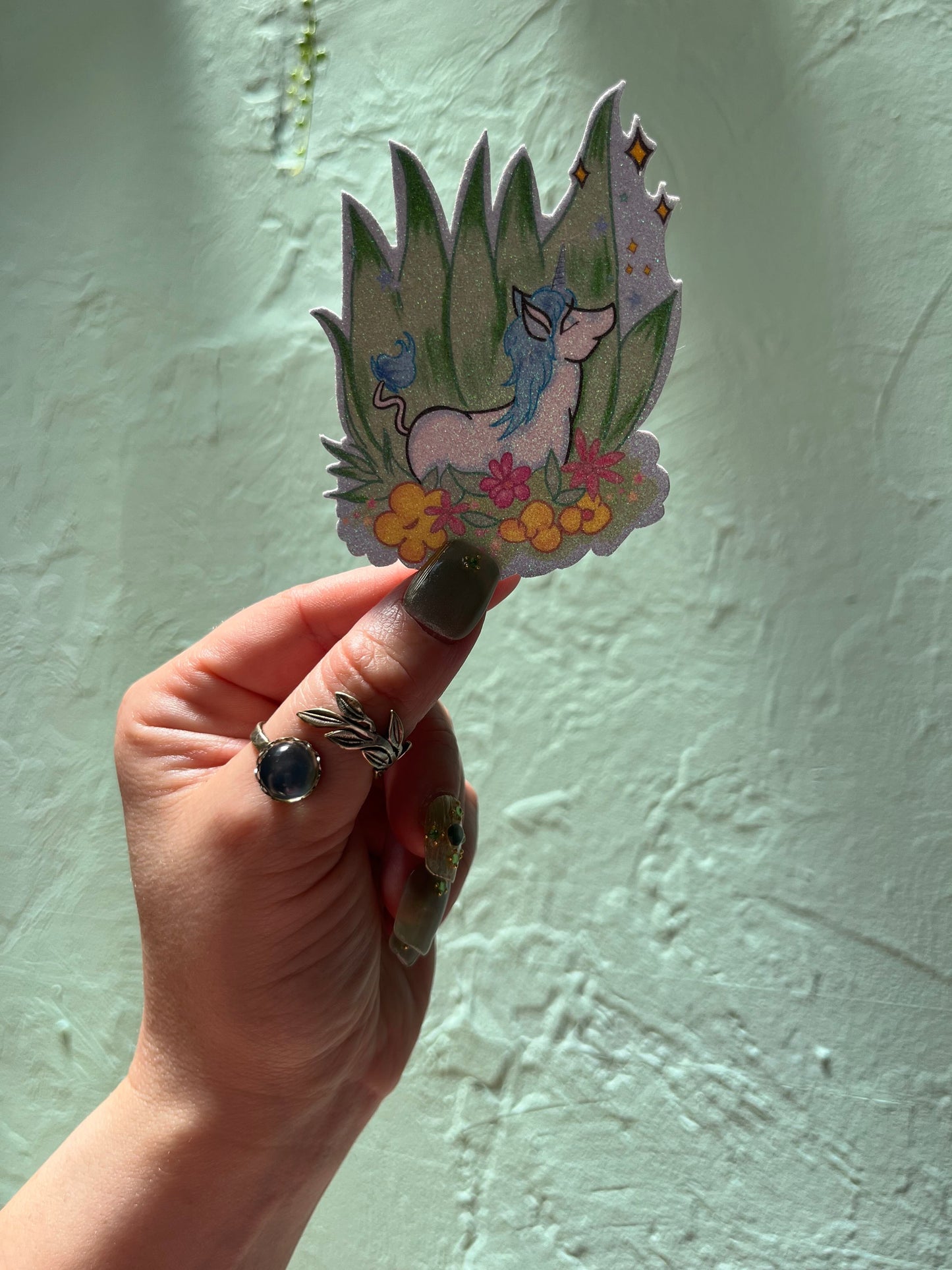 Blue Unicorn Resting Among the Flowers Glitter Sticker