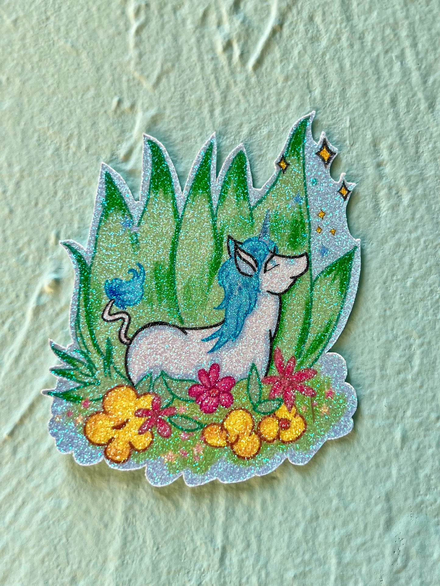 Blue Unicorn Resting Among the Flowers Glitter Sticker